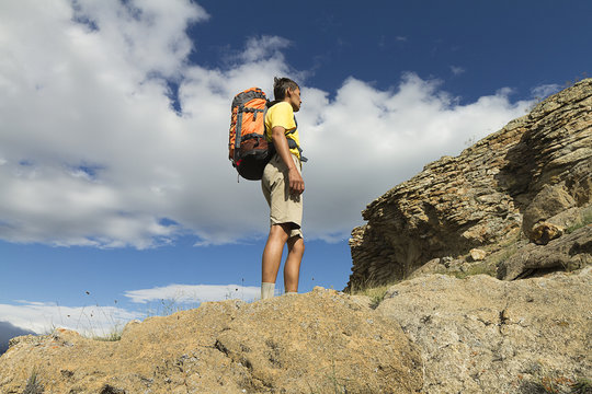  Hiking in the summer,  young man with a backpack