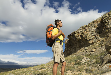 Fototapeta premium young male hiker in the mountains, mountain walk