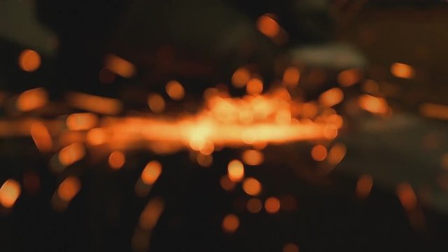 Welder of Metal Grinding with sparks blurred focus , motion
