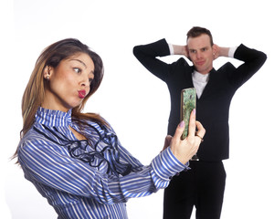 young woman makes selfie with mobile phone while boss looks from