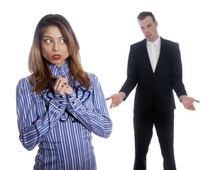 female subordinate worries anxiously while male boss stands in b
