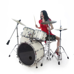 Fototapeta premium sexy brunette in red dress plays drum kit in studio