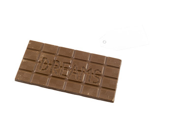 The word dreams carved in a chocolate bar. Sweet dreams concept