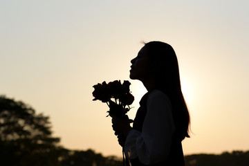 Silhouette women who are happy with roses.