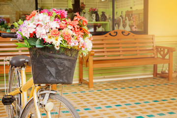 Fototapeta na wymiar Colorful flowers in the basket of a bicycle. making light soft