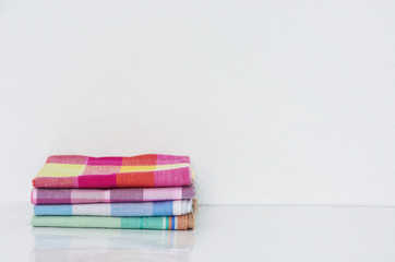 stack of folded handkerchiefs on white background, copy space