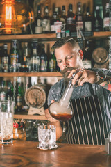 Handsome barman is making cocktail