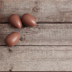 Chocolate Easter Eggs Over Wooden Background