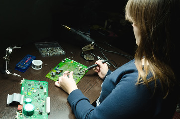 Young woman technician repair electronics device