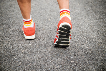 Young man run on road , close up on shoe