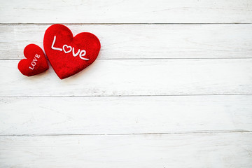 Love hearts hanging on rope on a white wooden background