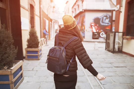 Woman Walking Away In A City Street