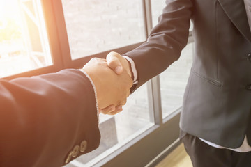 Business handshake. Two businessman shaking hands in the office.