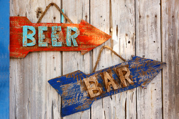 Closeup Beer and Bar Sign on a Rusted Wood Board.