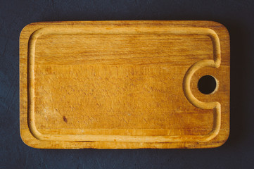 Old cutting Board on a dark background. Top view