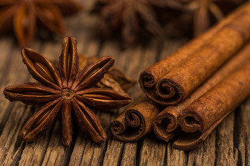 Star anise and cinnamon on old wooden table.