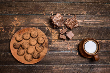 Cup of hot coffee with broken slices of chocolate, chocolate  truffles