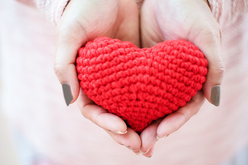 Female hands holding a red heart. The Valentines day