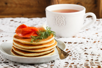 Potato and cheese pancakes with salted red fish cream cheese and dill. Breakfast. Selective focus
