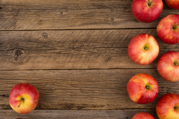 Red apples on the old wooden table.