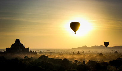 Sunrise with hot air balloons hovering over pagodas in bagan, Myanmar.