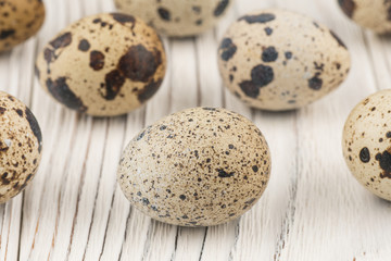 Quail egg on old white wooden table.