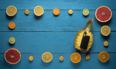 black vaporizer surrounded by citrus