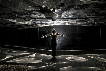 Conceptual photo of young and naked man is standing with hands u