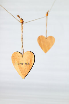 Wooden heart with the inscription "I love you" hanging on a rope