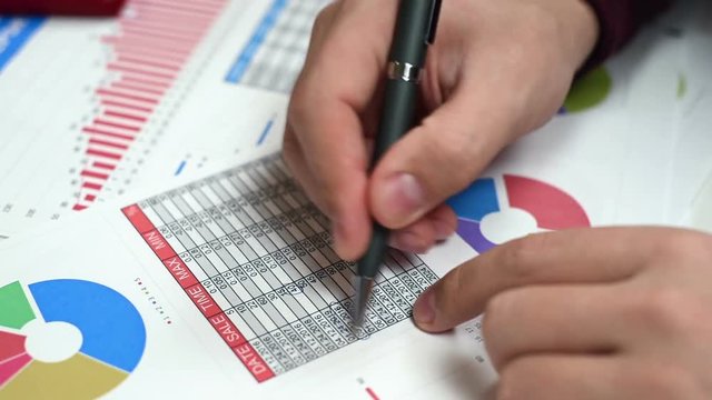 Accountant Man Checks Financial Report And Analyzes Stock Exchange Statistics
