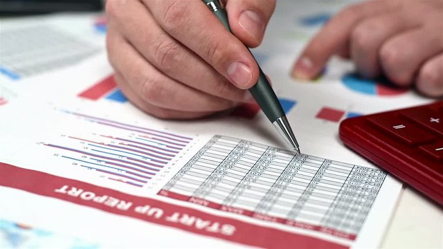 Businessman Analyzes Stock Exchange Statistics. Close Up