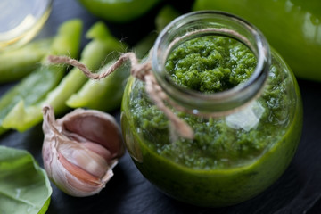 Close-up of a glass jar with freshly made chimmichurri sauce