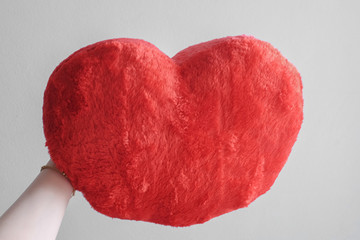 Valentine red heart-shaped pillow on the marble floor