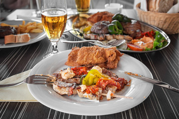 Chicken skewers with vegetables on white plate