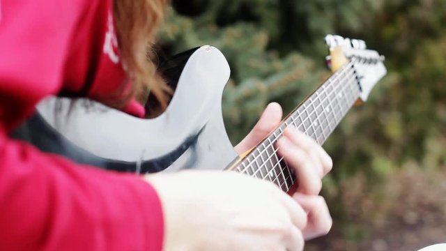 Guitarist plays solo close up