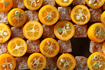 slices of kumquat with pieces of brown sugar, top view