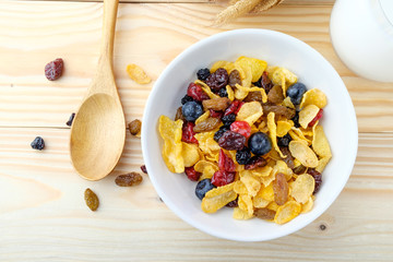 Corn flakes and Berries on wooden background
