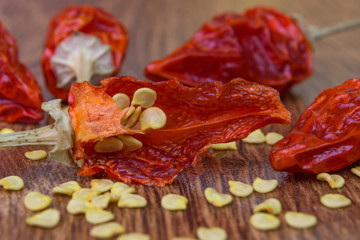 cut, dried, small red chili pepper on wood background, close-up