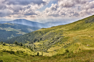 Summer landscape in mountains and the dark blue sky with clouds