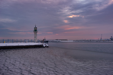 Fototapeta premium Winter fire sunset and frozen sea at the Marine station, Burgas, Bulgaria
