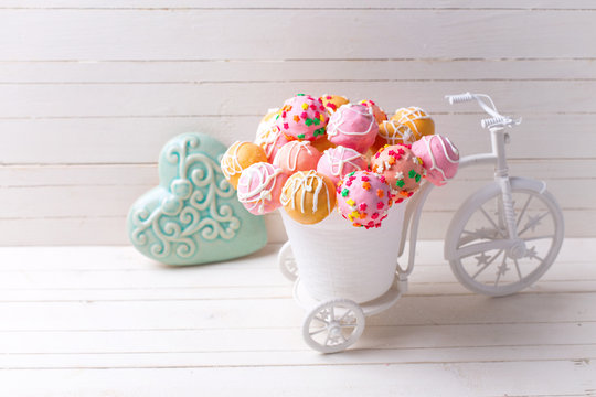 Colorful cake pops  in decorative bicycle and turquoise heart  o