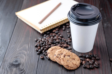 Coffee cup and coffee beans on wooden background