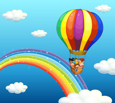 Children riding in big balloon over the rainbow