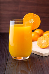 Orange juice on wooden background