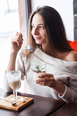 young beautiful woman eating a dessert
