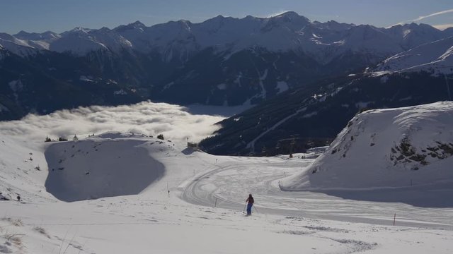 Lone skier coming down the mountain in ski resort