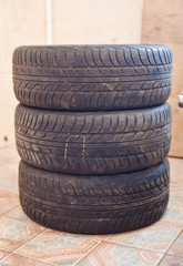 Stack of old car tire with erased tread