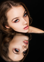 Fototapeta na wymiar Beauty makeup fashion model on mirror reflection