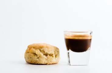 Cup of espresso coffee and scone.
