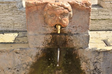 Source with sculpture of a face in Verona, Italy